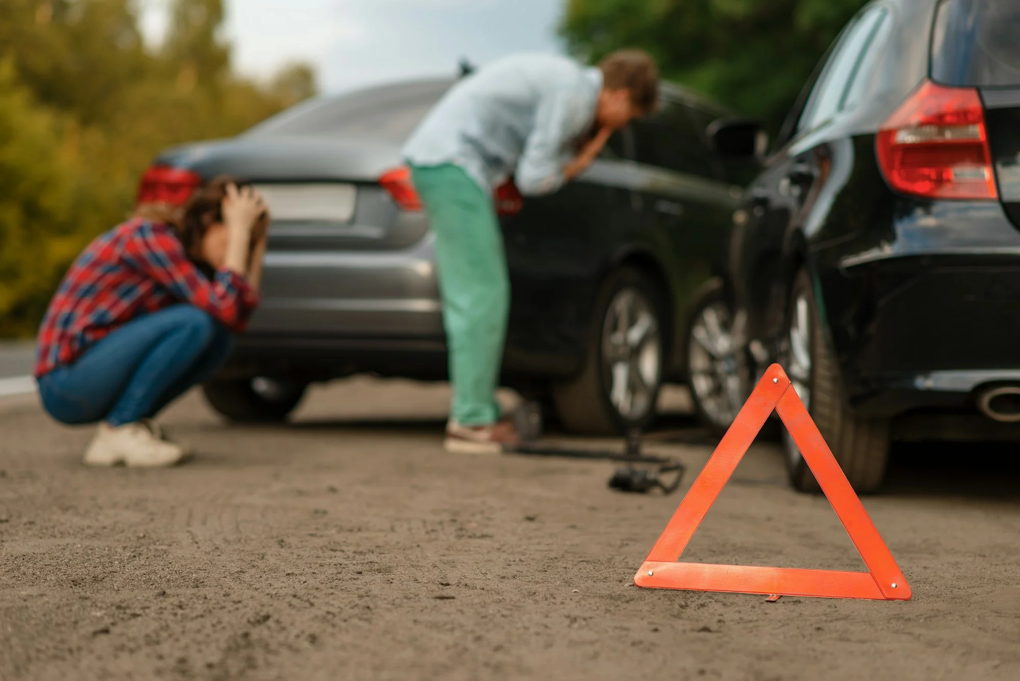 Car accident on road, male and female drivers